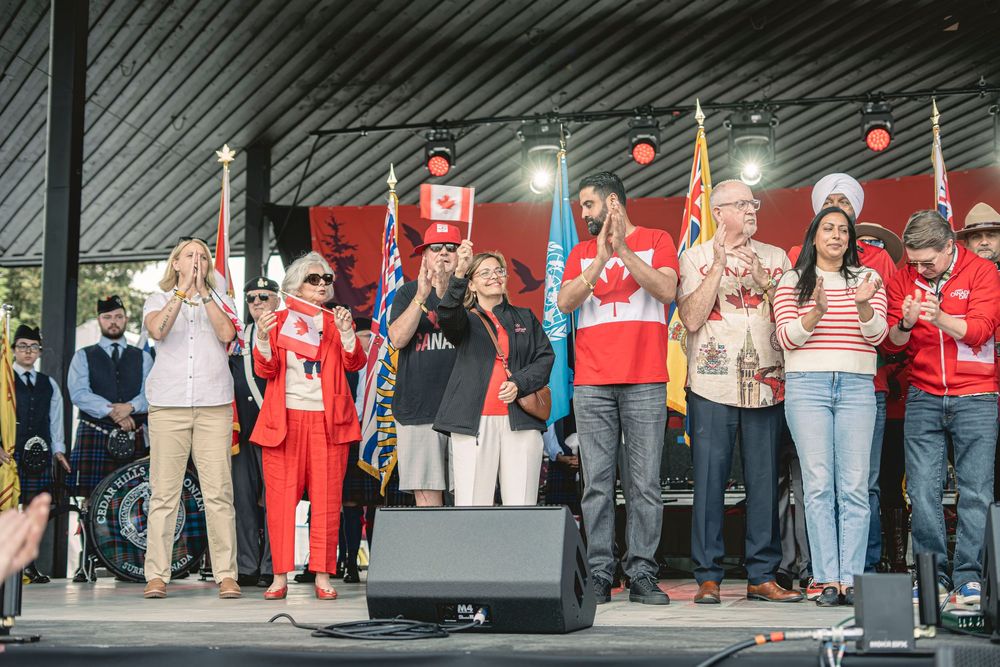 Group gathered on stage with Canadian flags