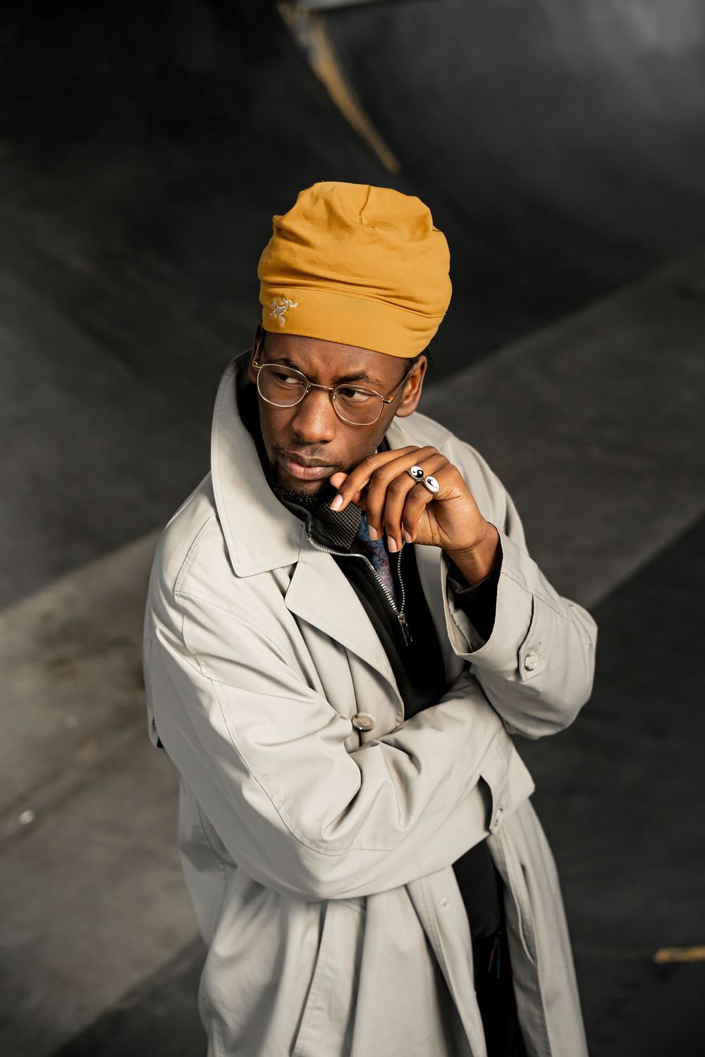 Portrait in a light trench coat and mustard headwear
