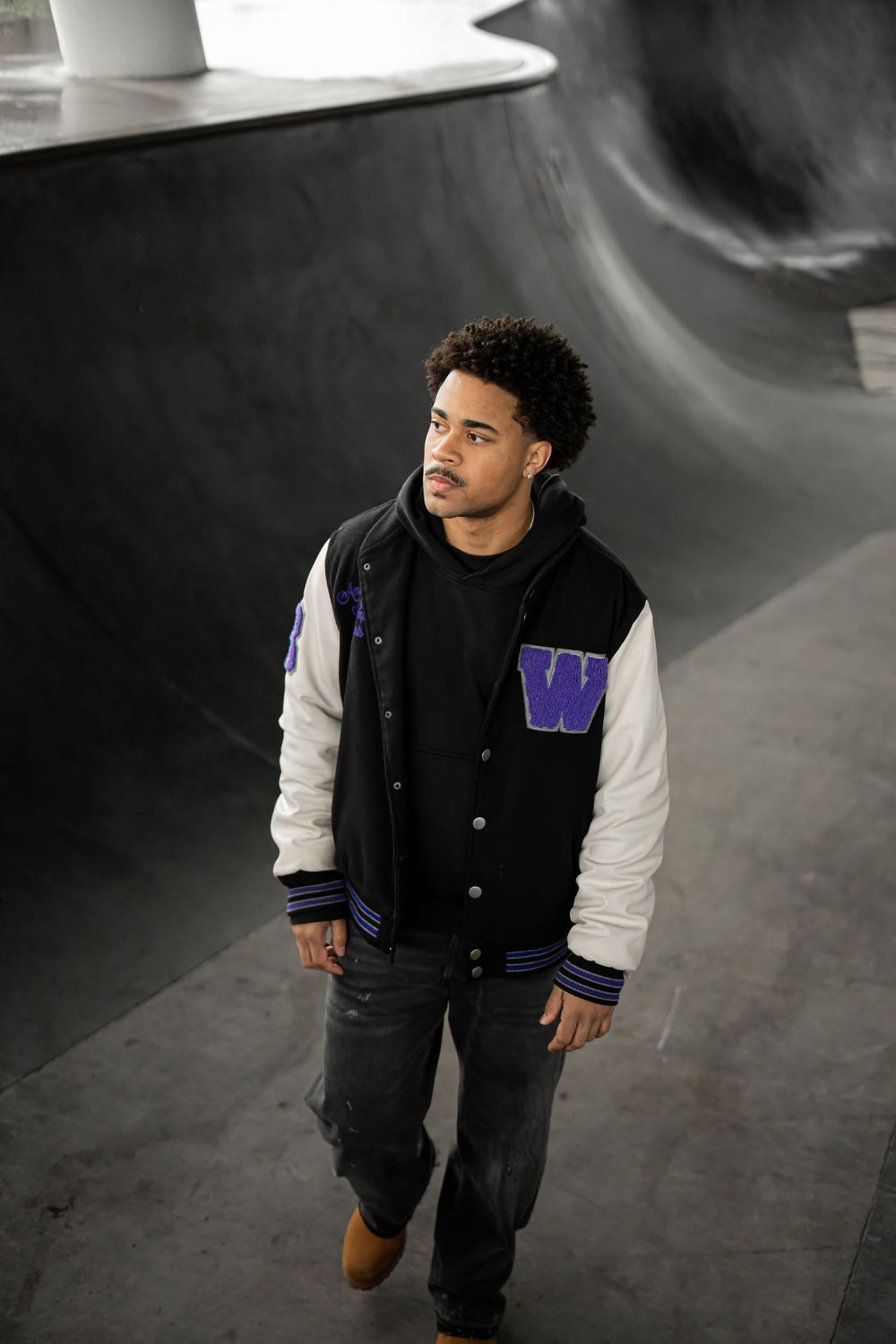 Fashion portrait in a black and white varsity jacket