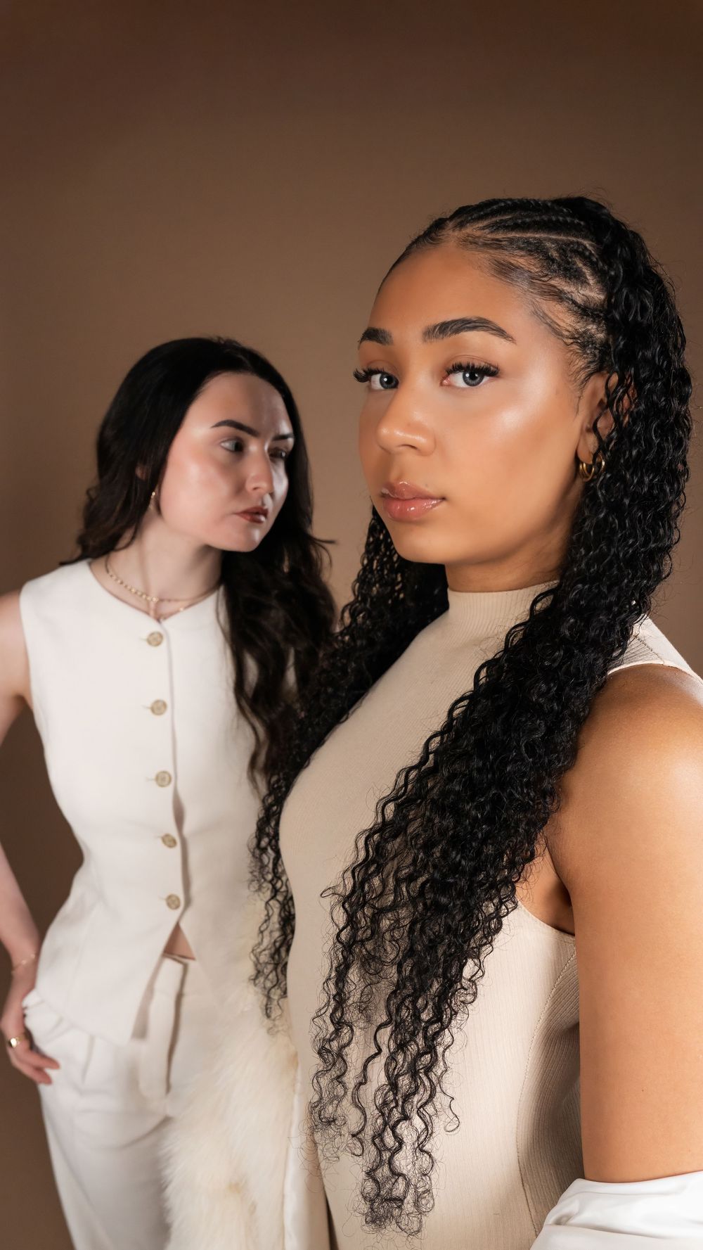 Close portrait of two models in cream outfits